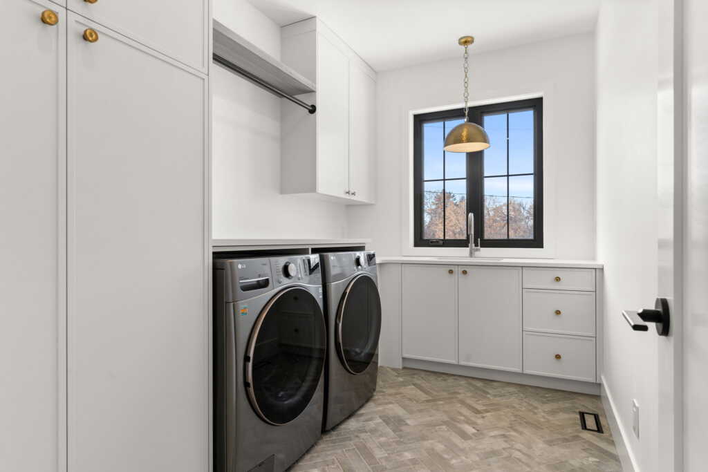 Laundry room with white cabinetry